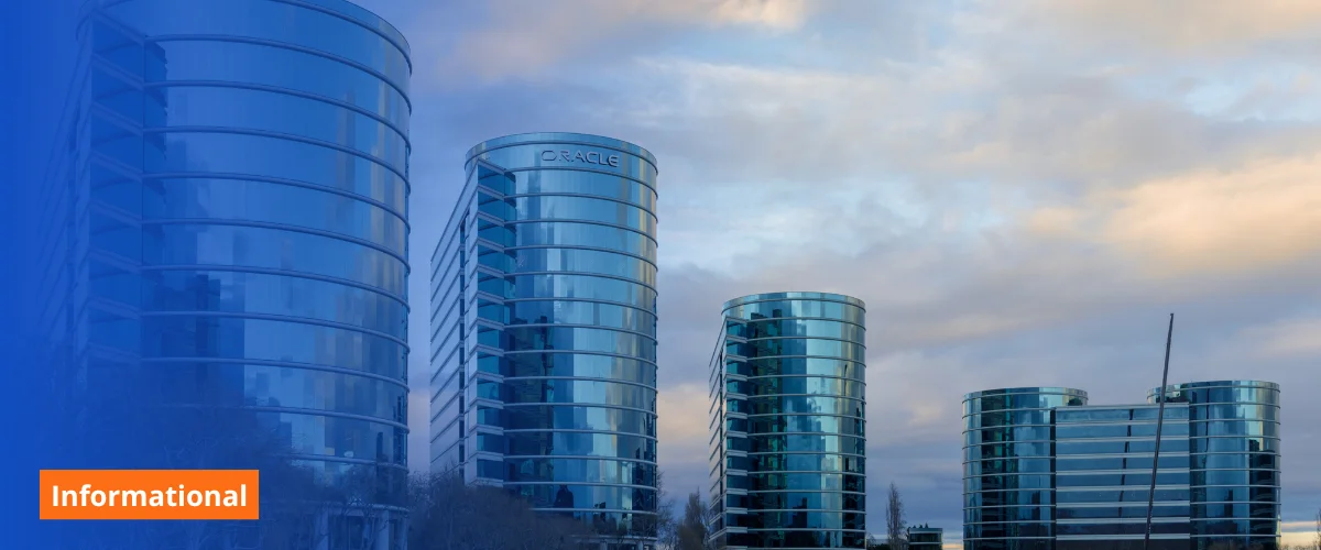Blue-tinted glass office towers under a cloudy sky, labeled Informational